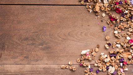 Top view workspace with dried flowers on wooden table background