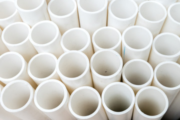 white PVC pipes stacked on a pallet
