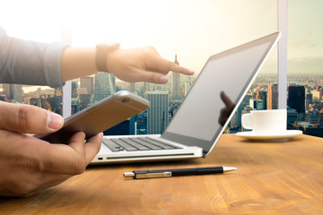 Cropped shot Silhouette of a man's hands using a laptop at home,