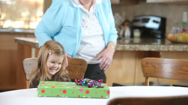 Senior woman gives Great Granddaughter a gift