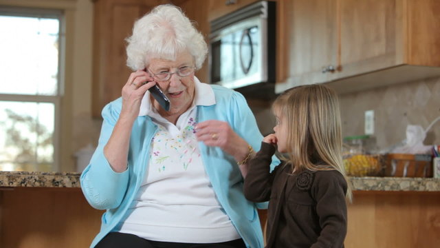 Senior woman talks on phone with Great Granddaughter