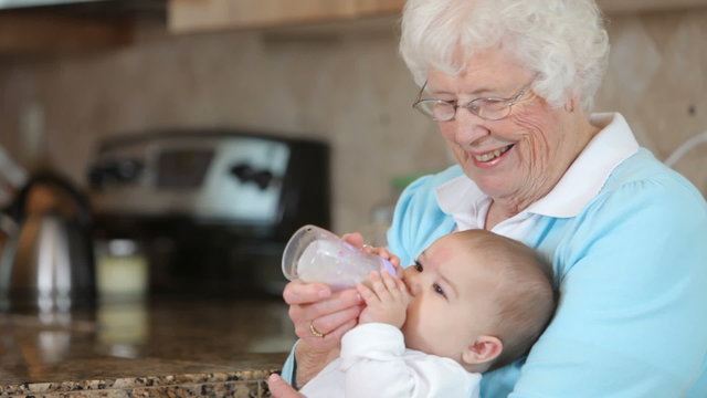 Great Grandmother feeding baby with a bottle