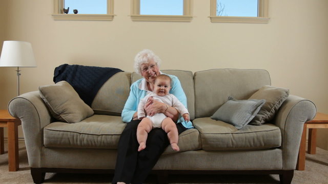 Elderly Great Grandmother sitting with baby