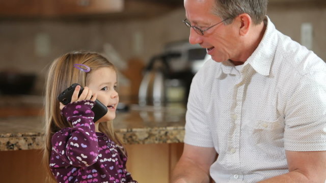 Grandfather talking on phone with granddaughter
