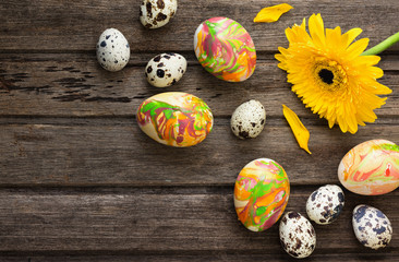 Easter background with eggs, flowers, and decoration on wooden b