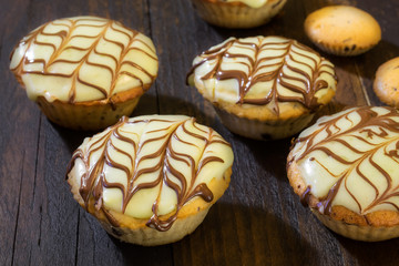 Fresh baked chocolate muffins on vintage wooden table