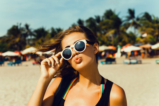 Summer lifestyle happy smiling portrait of pretty young woman blonde fashion having fun on the beach on tropic island in sunglasses,holiday,lipstick,cover,beauty,student,reading,miami beach
