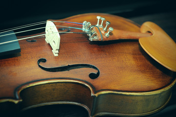 Detail of violin on dark background