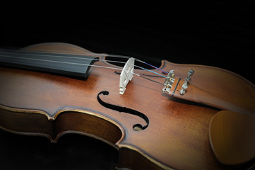 Detail of violin on dark background