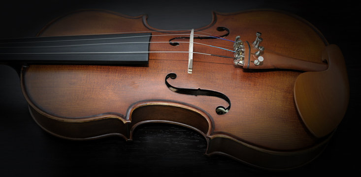 Detail of violin on dark background