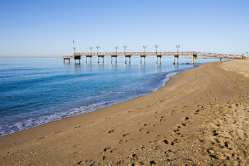 Fototapeta na wymiar Beach and Pier in Marbella on Costa del Sol