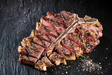 Grilled medium rare t-bone steak with seasoning