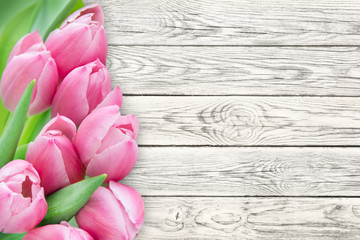 Tulips against wooden background