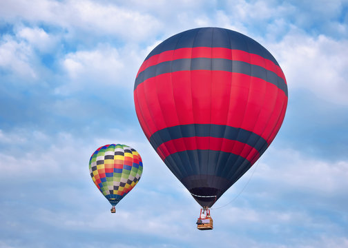 Pair Of Colorful Hot Air Balloon in Cloudy Blue Sky