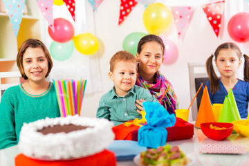 Group of adorable kids having fun at birthday party, selectiv focus