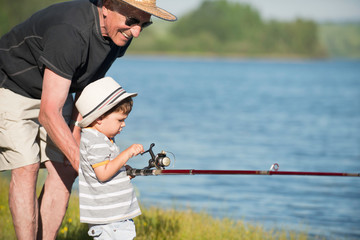 Grandfather having great time with his grandson, fishing