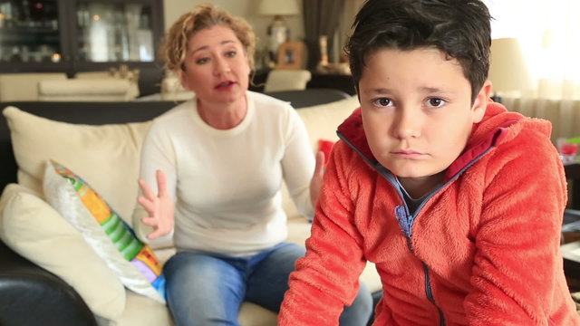 Angry mother scolding a disobedient child 