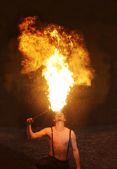 Fire Breather Circus Flame Show. Large Plume Of Flame