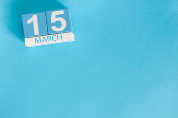 March 15th. Image of march 15 wooden color calendar on blue background.  Spring day, empty space...
