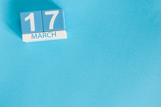 Happy St Patricks Day save the date. March 17th. Image of march 17 wooden color calendar on blue background.  Spring day, empty space for text