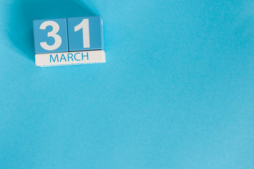 March 31st. Image of march 31 wooden color calendar on blue background.  Spring day, empty space...