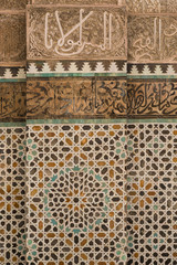 tile work and carved calligraphy in the 14th century Bou Inania medrese in Fes
