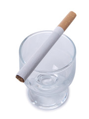 Glass of whiskey and cigarettes on white background