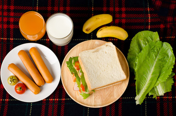 Breakfast,meal,fried egg,sandwich,sausage,orange juice,milk