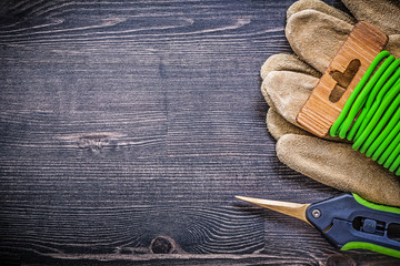 Composition of garden clippers tie wire protective gloves on vin