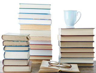 Books, glasses and a cup of tea with isolated background