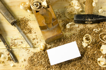 Carpenter tools on wooden table with sawdust. Craftperson workplace top view