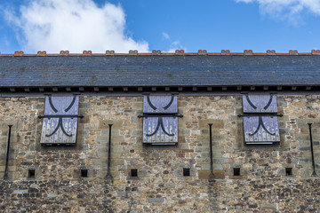 Windows, with wooden shutters, in a castle wall