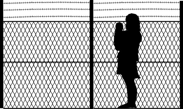a mother in front of a security fence 