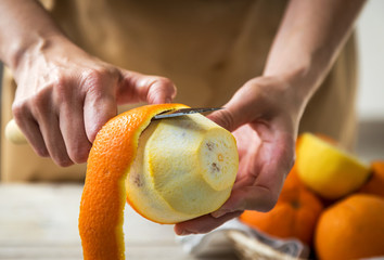 Person peels an orange