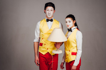  two funny mimes isolated on white background. lamp