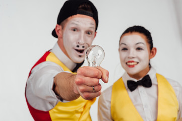 two funny mimes isolated on white background. lamp