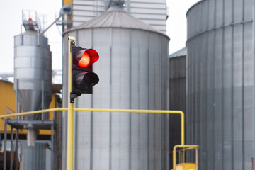 traffic lights and agricultural grain elevator building for grain storage and railroad