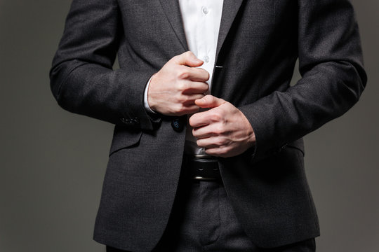 Hands of handsome businessman in black suit and white shirt