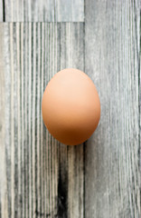 One egg on a wooden blue surface