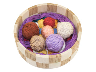 knitting and accessory in a wooden basket isolated on a white background