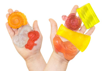 handmade color pieces of soap in kids palms isolated on a white background