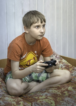 boy plays the Xbox in the room