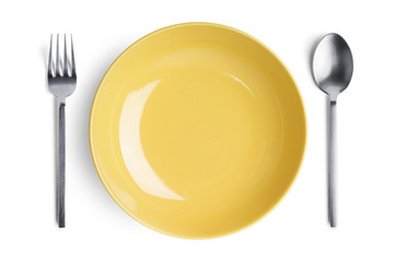 A yellow plate with silver fork and spoon