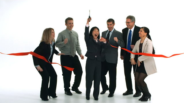 Group of businesspeople cut ribbon and celebrate, slow motion