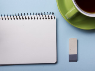 Office table with supply and coffe cup. View from above. Copy space for text