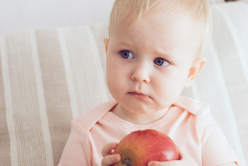 little girl eating an apple