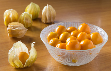 orange gooseberries in bowl and on tables