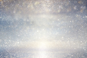 glitter vintage lights background. silver, blue and white. defocused. 