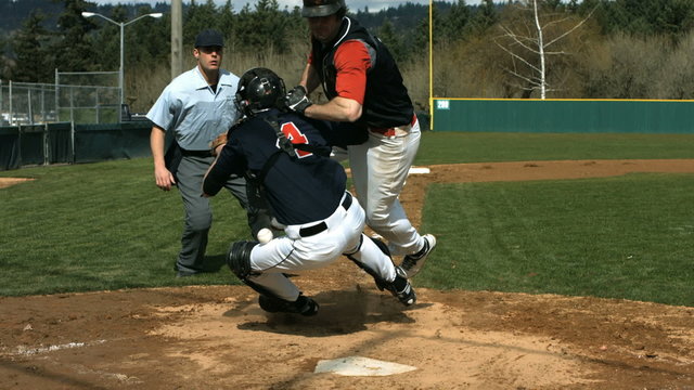 Baseball players collide at home plate