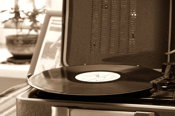 The vintage player of vinyl records with a retro toning